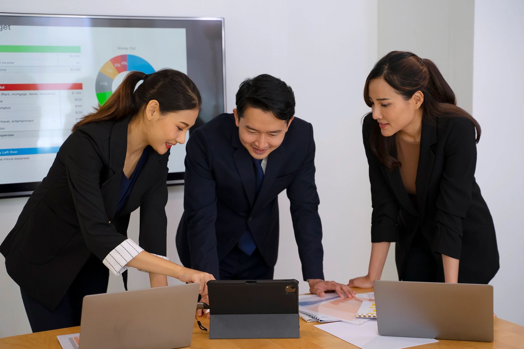 Professional team meeting in office reviewing survey project progress