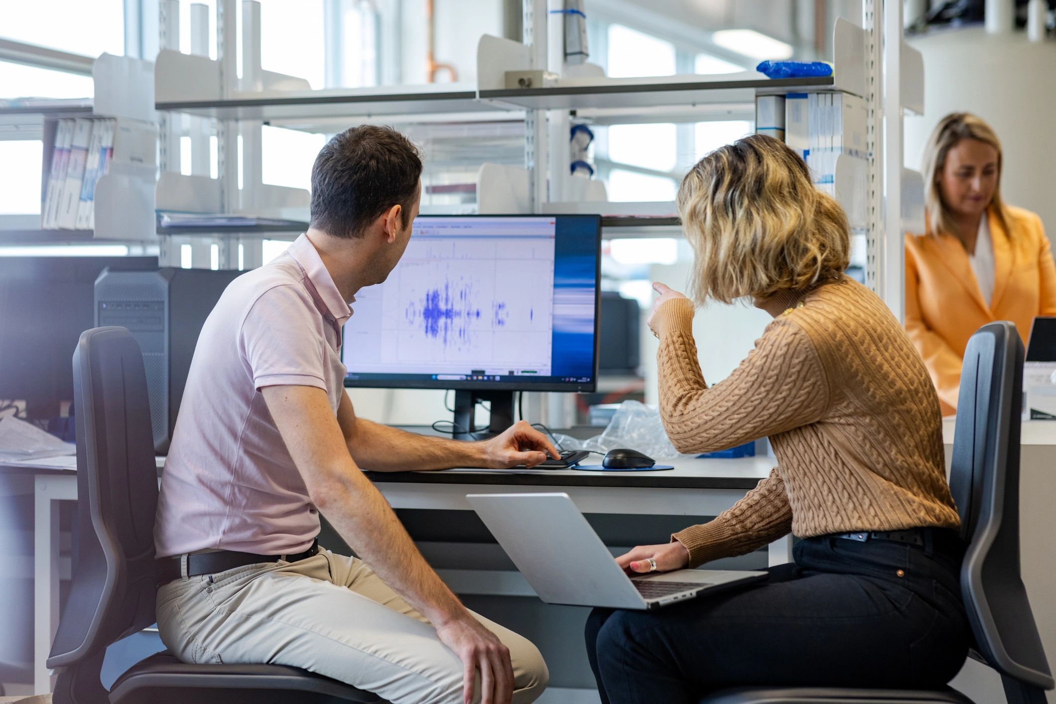 Research professionals reviewing study data on a computer