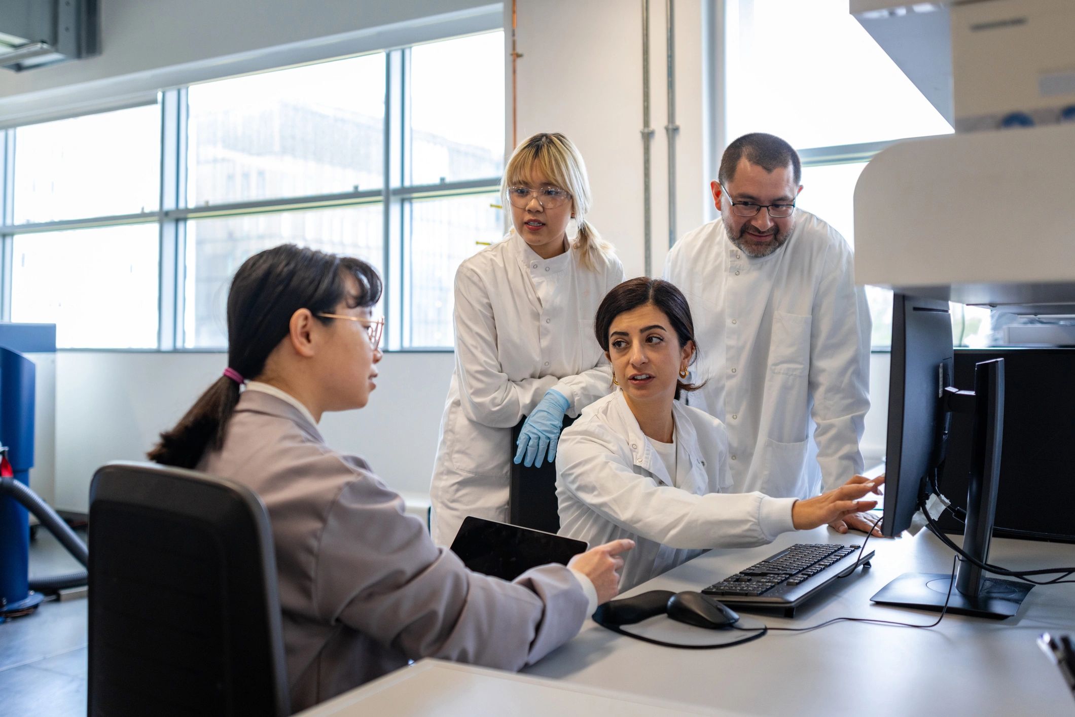 Research team working together representing a healthcare research client testimonial
