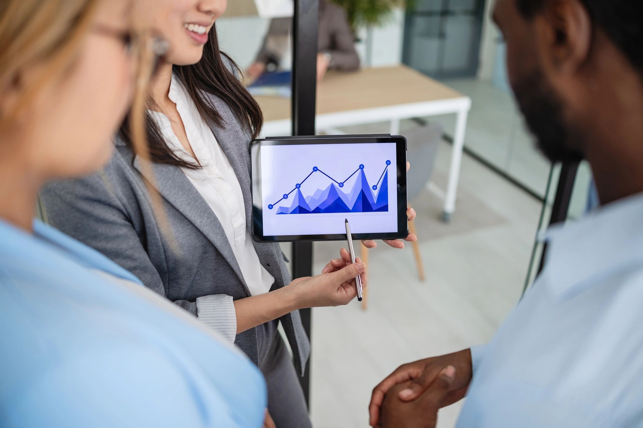 Professionals reviewing analytics on a tablet