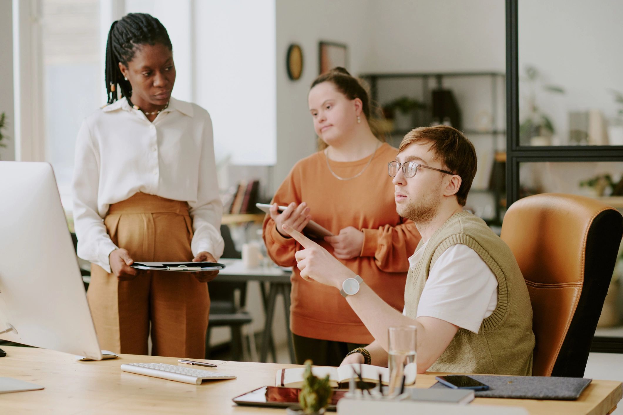 Professional team reviewing plans on a computer screen