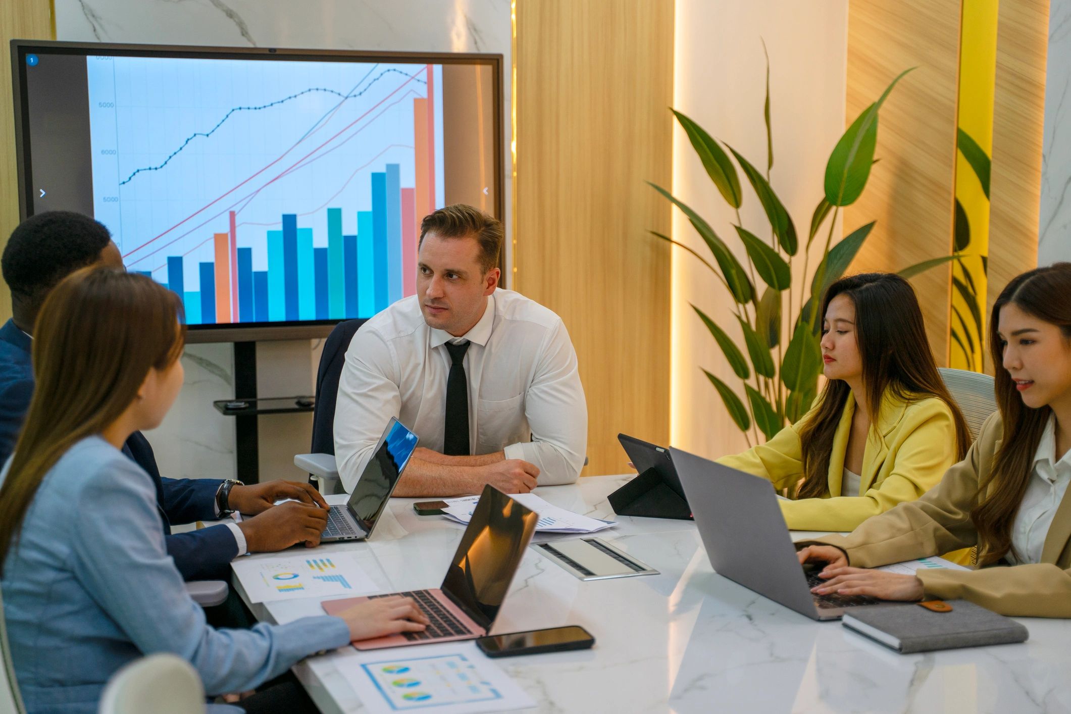 Business team meeting around a laptop